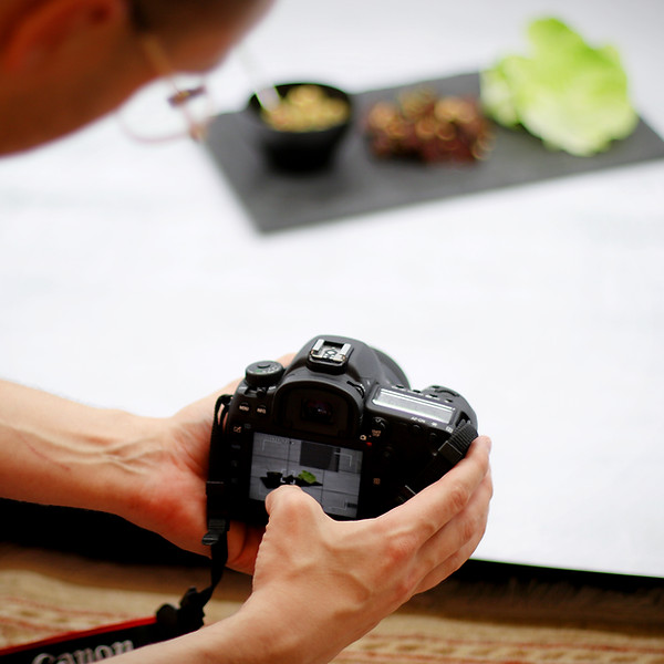 Evan's hands in lightbox holding camera
